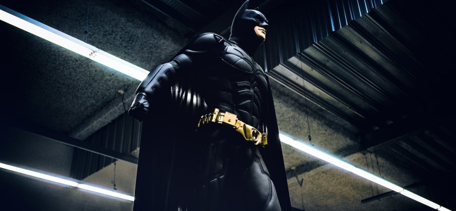 Batman standing under steel roof